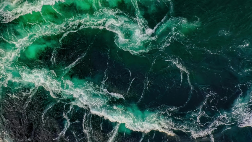 Waves of water of the river and the sea meet each other during high tide and low tide. Whirlpools of the maelstrom of Saltstraumen, Nordland, Norway Royalty-Free Stock Footage #1065223177