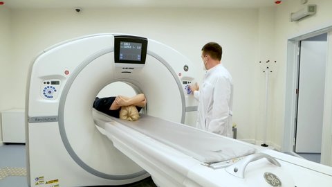 Chelyabinsk, Chelyabinsk region, Russia - 26.11.2020: Using a CT scan to detect a coronavirus infection.

Doctor prepares for a computer tomography scan of the patient.