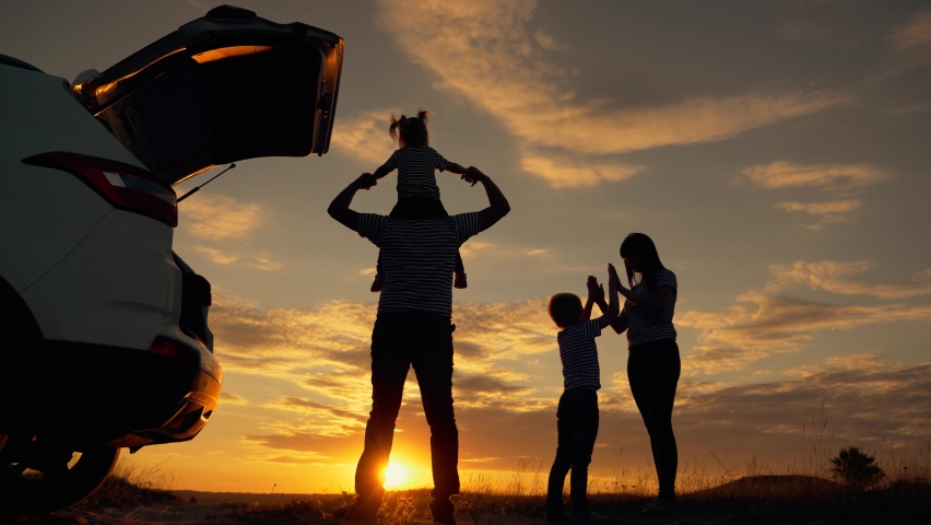 Happy family in the park. Silhouette of happy family in the park at sunset. Parents play with their children at sunset. Silhouette of group of people field. Happy family and vacation concept | Shutterstock HD Video #1065225808