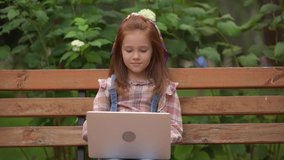 emotional child having video chat on laptop in park