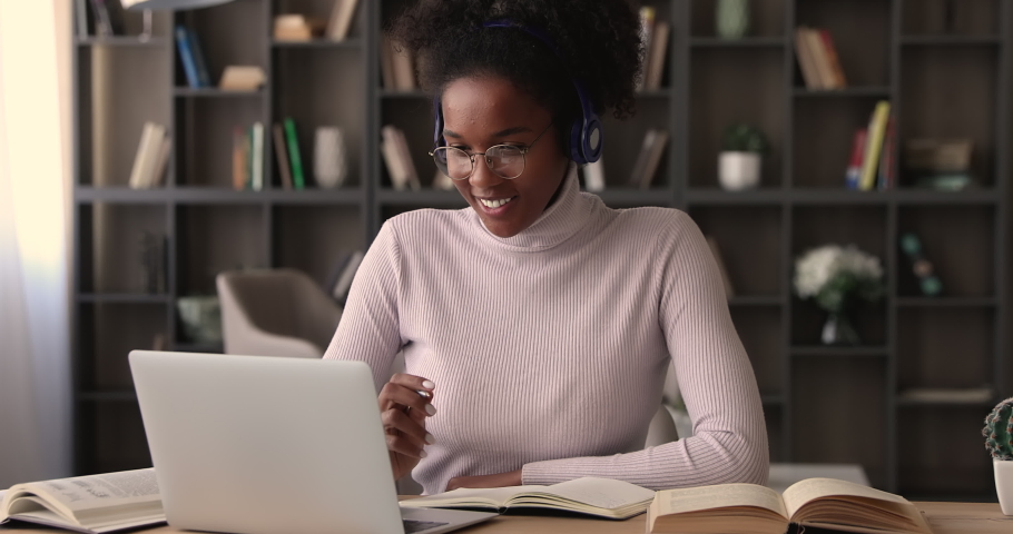 Diligent african student listen audio online course on laptop through headphones enjoy interesting remote study. University admission educational webinar, internet resources for self-education concept | Shutterstock HD Video #1065237712