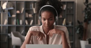 African student communicates with mate by video call app on laptop, woman wear wireless headphones talk to friend remotely using modern tech and video conference application, videocall event concept