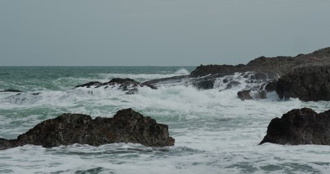 Sea water waves break on rocks