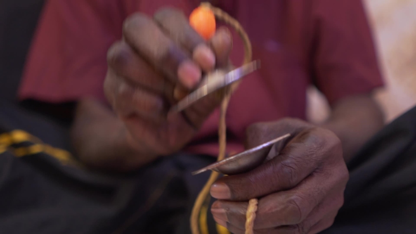 Man plays the indian musical instrument Manjira
