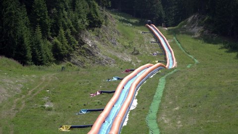 Long inflatable water slide on mountain in Bansko, Bulgaria