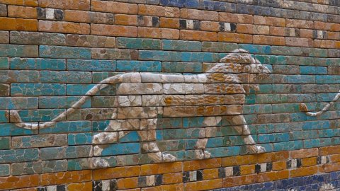 Beautiful glazed tiled bricks bas relief, decoration on ancient walls of Ishtar Gate of Babylon with images of Mesopotamian lions symbolizing the goddess, perspective, zoom in and pan, close up