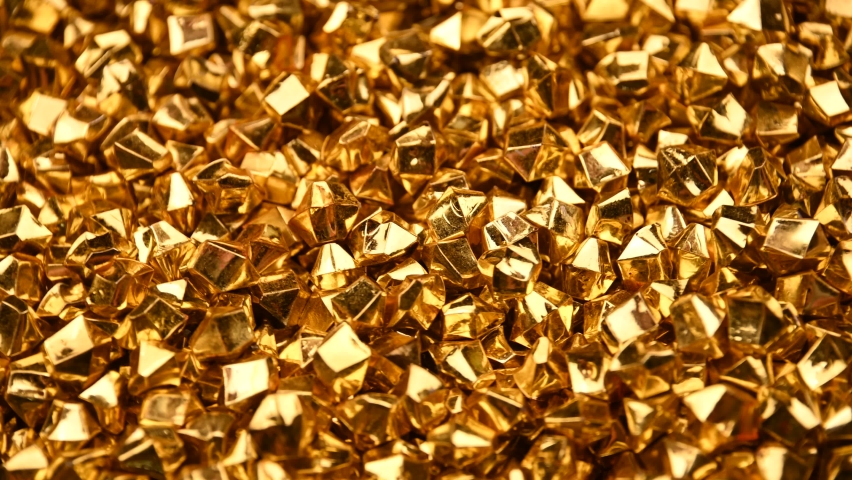 Abstract background of colorful bright golden nuggets spin and flicker, 4K