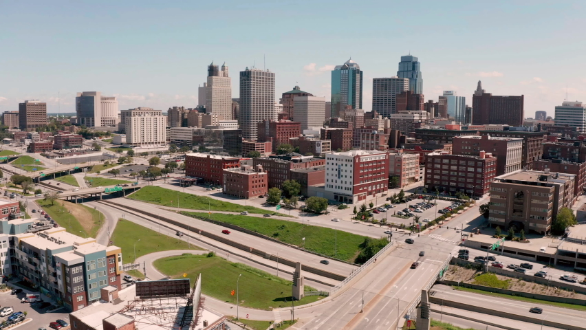 Aerial view flying in towards downtown Kansas City Missouri over highway and buildings