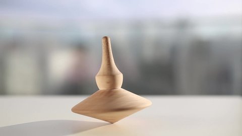 Wooden Totem spinning top coming to an end
