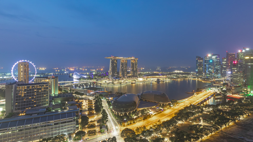 Singapore Sunrise Beautiful Time lapse of night to day of Singapore city skyline from aerial and high angle overlooking Marina bay and CBD area. Zoom out motion timelapse. Prores Full HD Royalty-Free Stock Footage #1065276496