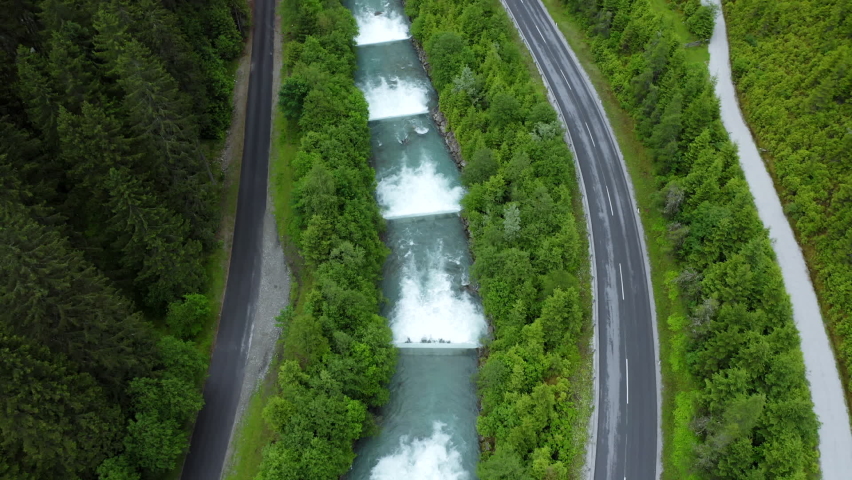 mountain road along cascade river reveal beautiful alpine valley