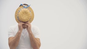 4k video of a joyful tourist in a straw hat wearing white shirt.