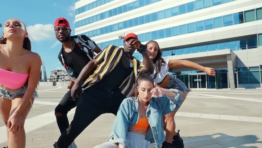Group of urban dancers performing outdoor. Multi-ethnic hip hop crew dancing and having fun Royalty-Free Stock Footage #1065278989