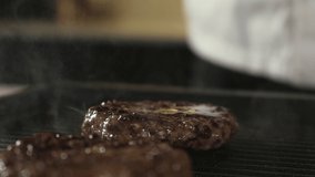 Cook kitchen prepares meat beef patties for delicious burger. chef places thin slice cheese on roast meat. Street food. Making sandwich for lunch and dinner. Barbecue with delicious homemade burgers - Powered by Shutterstock - Get 15% off with code: PIKWIZARD15