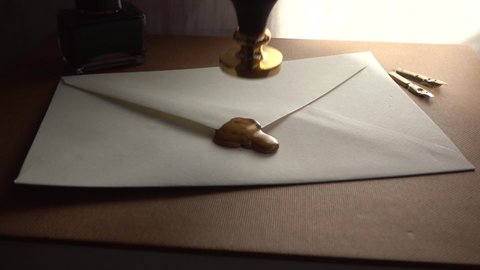 Concept of secret conversation sends in the past. 18th-century technique of mailing. Low light slow motion of stamping wax for sealing a secure letter. Medieval way to send encrypted secured messages.