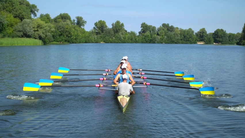 Rowing team summer training. 8 athletes rowers in a boat in the river Dnipro. City area in Kiev, Ukraine. Go Everywhere. Be H3althy Royalty-Free Stock Footage #1065301381