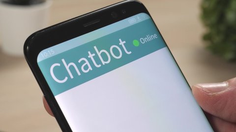 Having a conversation with a chatbot on a smartphone online support chat.