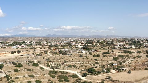 Aerial landscape view in Cyprus. villages with houses, streets, agricultural fields and plantations at the foot of mountains and mountain range