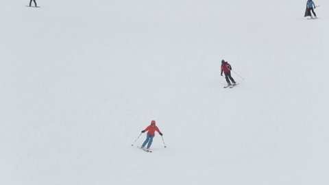 Bjelasnica, Bosnia and Herzegovina-January 20th 2019.-Slow motion of two skiers skiing down a hill