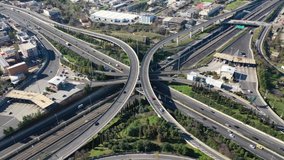 Aerial drone time-lapse rotational video of modern multilevel junction with crossing bridges, passing through National road of Athens and Attiki odos motorway