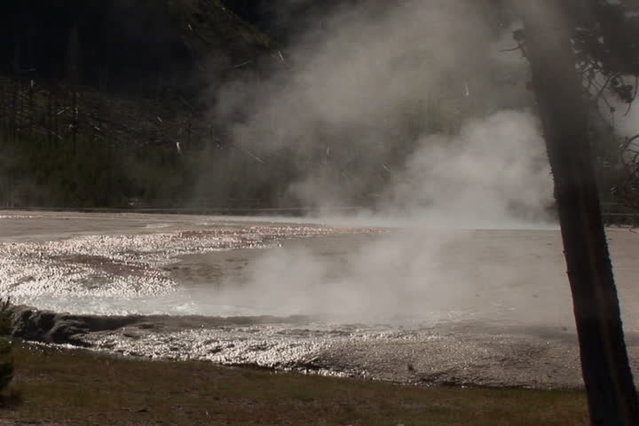 NTSC: Geyser shot against the sun, Yellowstone National Park. 