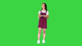 Frustrated little girl gamer experiencing game over on a Green Screen, Chroma Key.