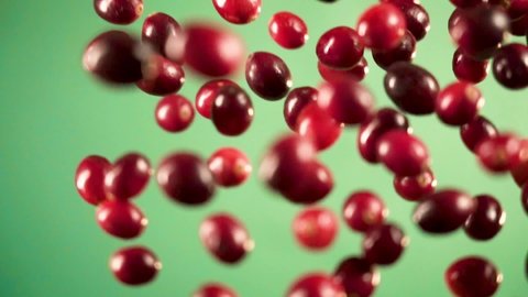 Cranberries flying into the air in slow motion. 