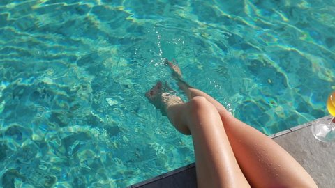 Young beautiful woman relaxing in swimming pool at spa resort. 
