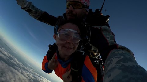 Russia. Tanay 18-23 August 2020: Parachute Weekend on Tanay: Free Fall of Two Parachutists in Tandem. Real Shooting Parachute Jump. Selfie. Signs with Hands to Camera. Extreme. Flight. Funny Faces