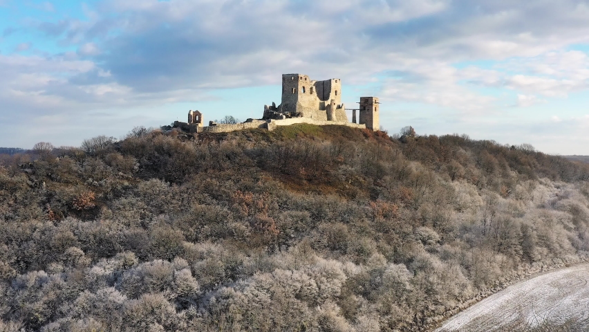 Snow covered historical castle ruins next to Csesznek city in hUngary. Amazing aerial 4K footage about a medival ruins. This place a part of Hungarian history. 