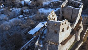 Snow covered historical castle ruins next to Csesznek city in hUngary. Amazing aerial 4K footage about a medival ruins. This place a part of Hungarian history. 