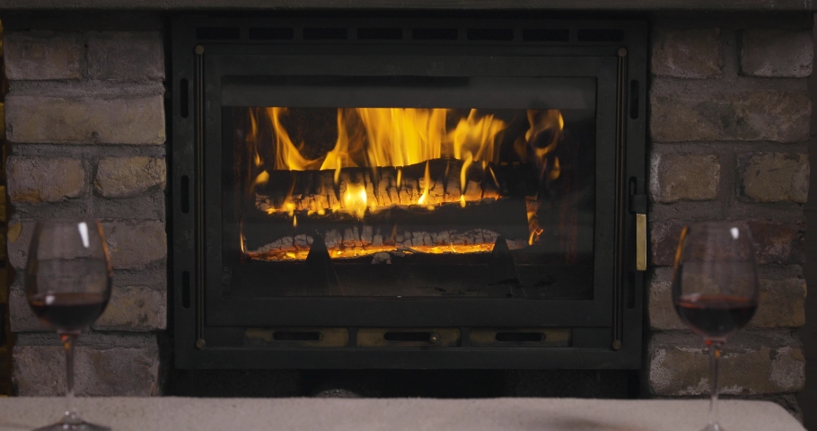Fireplace with burning fire and wine glases
