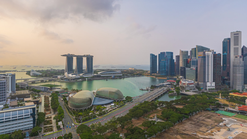 Singapore Sunset Beautiful Time lapse of day to night of Singapore city skyline from aerial and high angle overlooking Marina bay and CBD area. Pan left motion timelapse. Prores Full HD Royalty-Free Stock Footage #1065329548