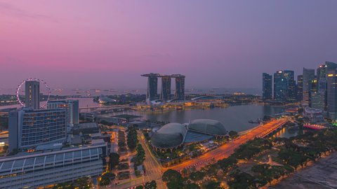 Singapore Sunset Beautiful Time lapse of day to night of Singapore city skyline from aerial and high angle overlooking Marina bay and CBD area. Pan left motion timelapse. Prores Full HD