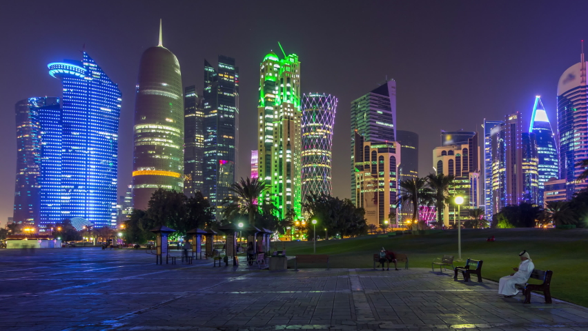The high-rise district of Doha night timelapse hyperlapse, seen from the Park. Illuminated skyscrapers and palms on west bay Royalty-Free Stock Footage #1065330946