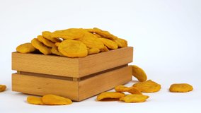  Dried fruits in wooden box on white background. Naturally, sun dried dried peach. Organic fruit isolated on white. Free space for text. High quality 4k video. Video set for footage.