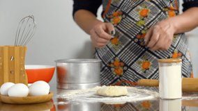 Woman's hand sifting flour in kitchen. Female's hand with dark manicure nails cooking in kitchen. Flour and dough. Cooking interior. High quality 4k video. Studio light.