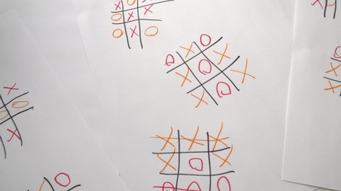 The player studies the game sheets with the results of the game of tic-tac-toe.