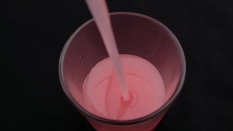 Pouring Guava Juice into a glass Top View.