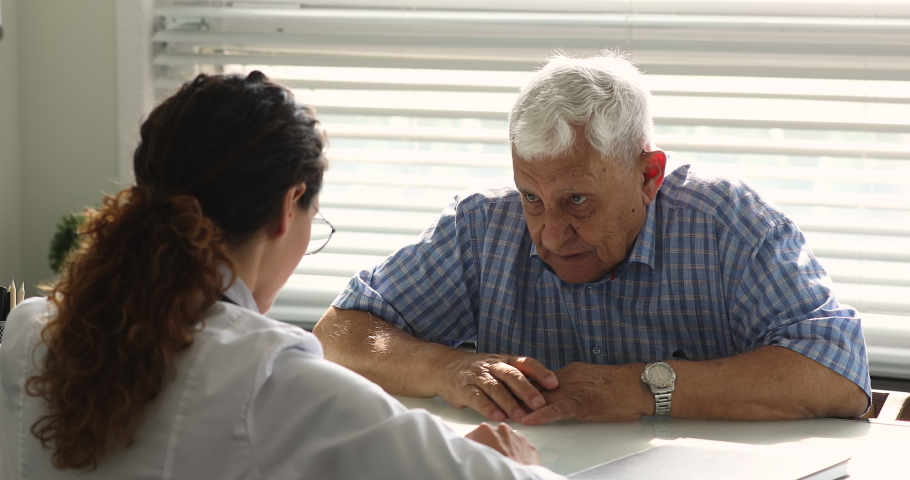 Satisfied elderly male patient shake hands with doctor express respect gratitude for qualified medical assistance received in clinic. Senile disease professional treatment, medicare service ad concept Royalty-Free Stock Footage #1065341344