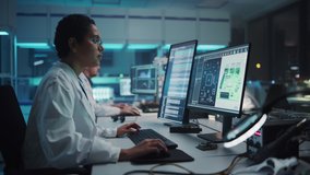 Modern Electronics Research Facility: Black Female Engineer Works on Computer with CAD 3D Design Software. Scientists Develop Industrial PCB, Silicon Microchips, Semiconductors. High Angle View - Powered by Shutterstock - Get 15% off with code: PIKWIZARD15