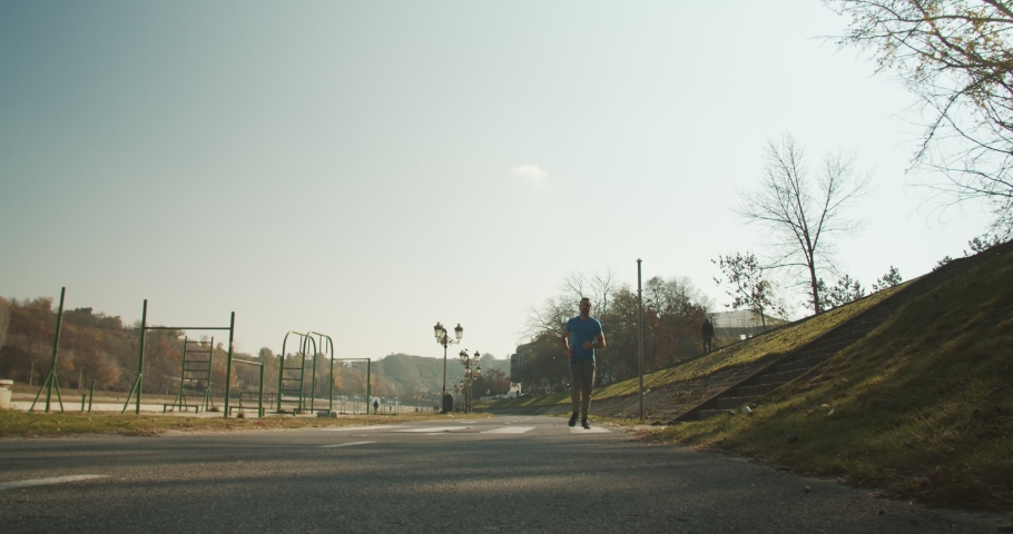 Adult man running in the mark in the morning