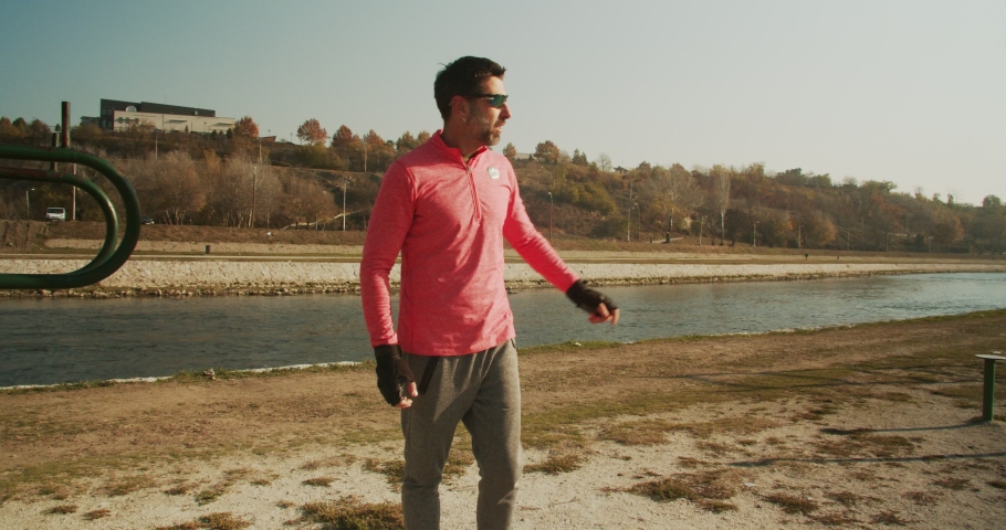 Adult man exercising outside in the park