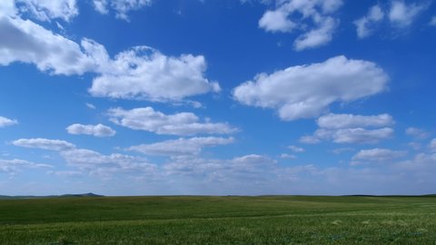 Time-lapse of blue sky and white clouds, cumulus floating by fast