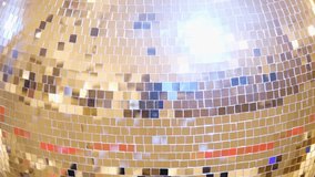 Bright large golden disco ball close up 4k resolution video Rotating retro disco ball background