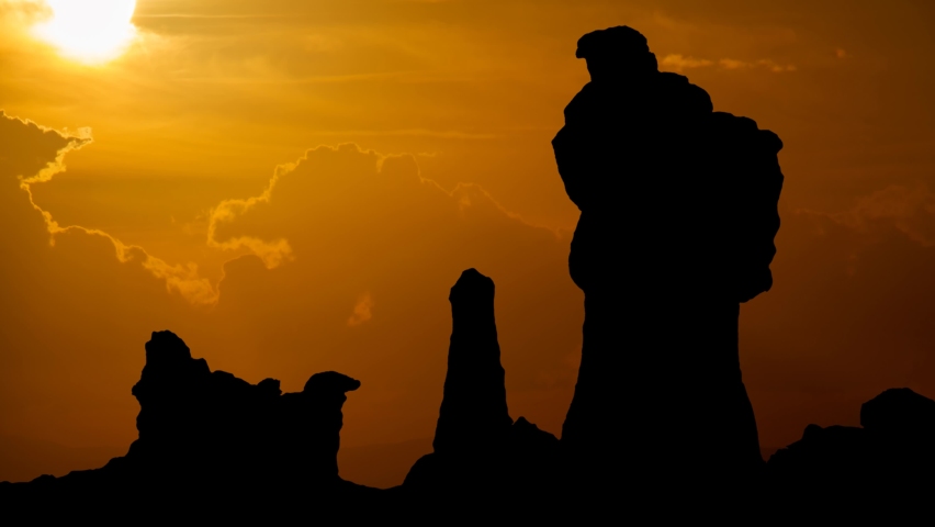Badlands National Park, Time Lapse at Sunset with Red Sun Fiery Sky and Dark Silhouette of Rocks, USA