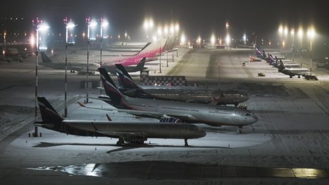 Moscow, Russia - January, 2021:  A row of Aeroflot passenger planes in the parking lot of Sheremetyevo International Airport. Some of them are being stored due to Covid-19. Cinematic shot