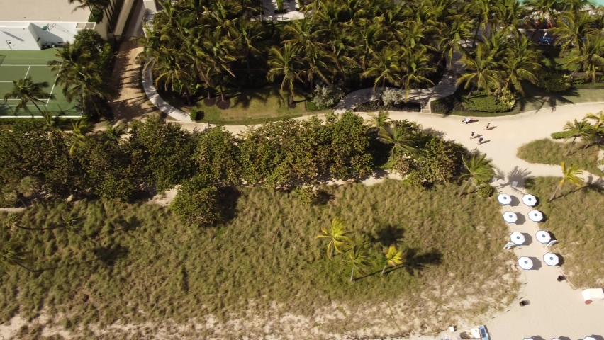 Aerial tilt up reveal Bal Harbour Miami FL condominiums 4k