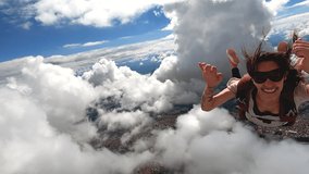 Video of a young woman parachutist smiling in free fall. Perfect concept of happiness and freedom. 59,94 fps in 4K resolution