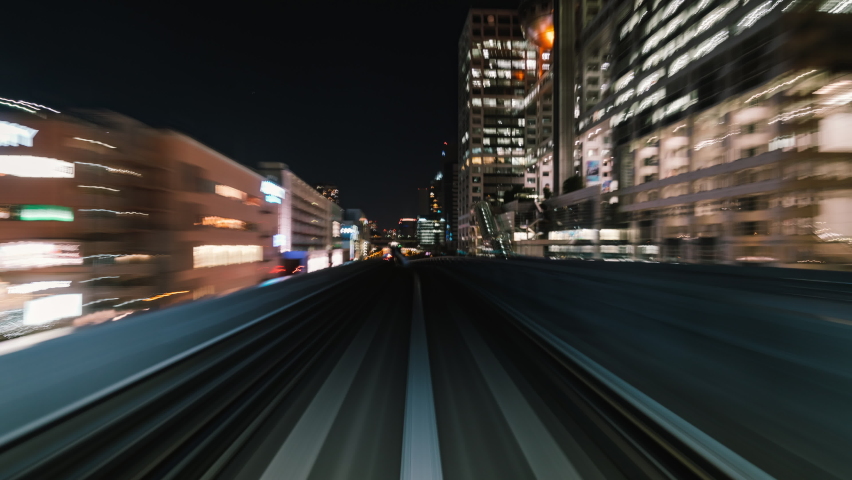 Point of view hyperlapse time-lapse of fast train travel forward on Yurikamome train line at night in Odaiba Tokyo, Japan. Railway transportation system, Asia tourism, transport technology concept Royalty-Free Stock Footage #1065369214